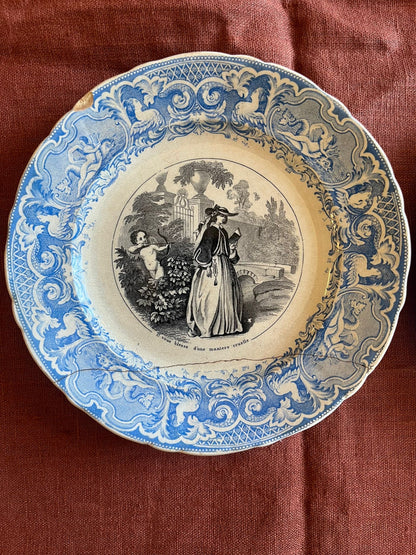 Paire d’assiettes parlantes terre de fer XIXe décor amoureux bleu